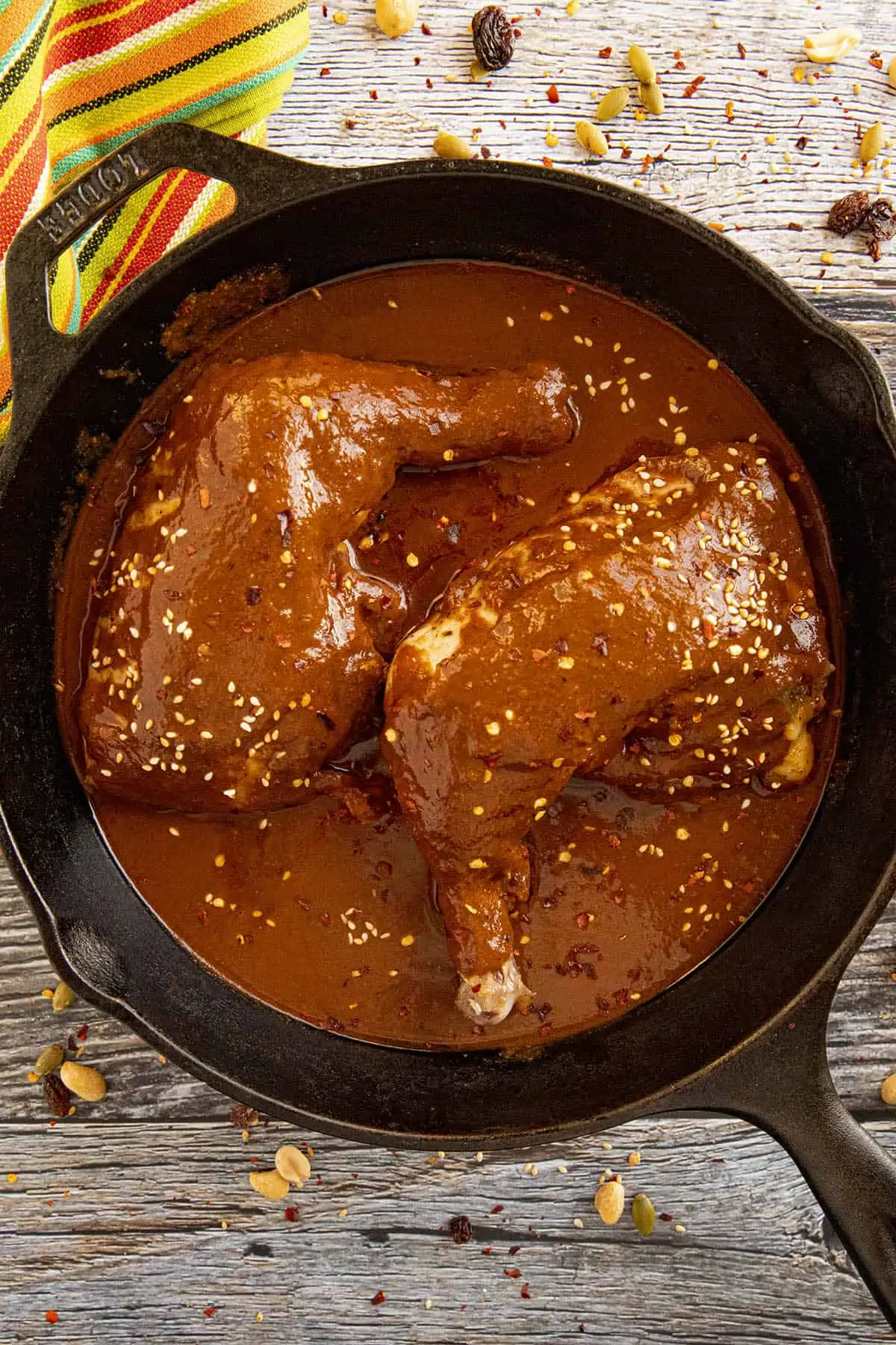 Chicken Mole in a pan with garnish.