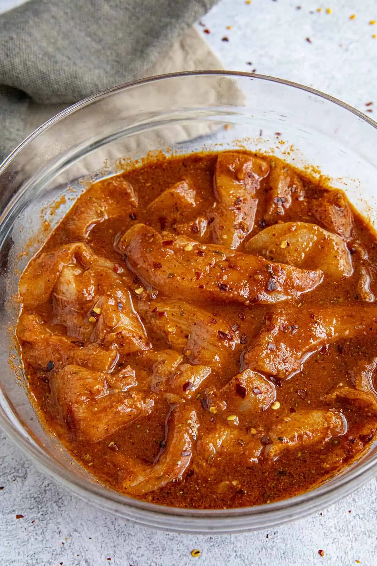 Slices of chicken marinating to make fajitas