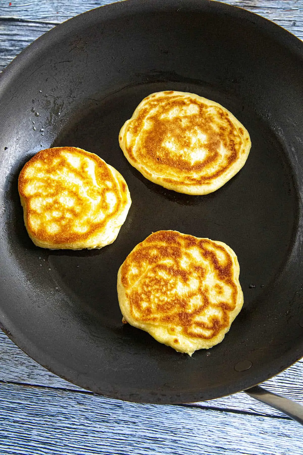 Johnny Cakes cooking in a hot pan