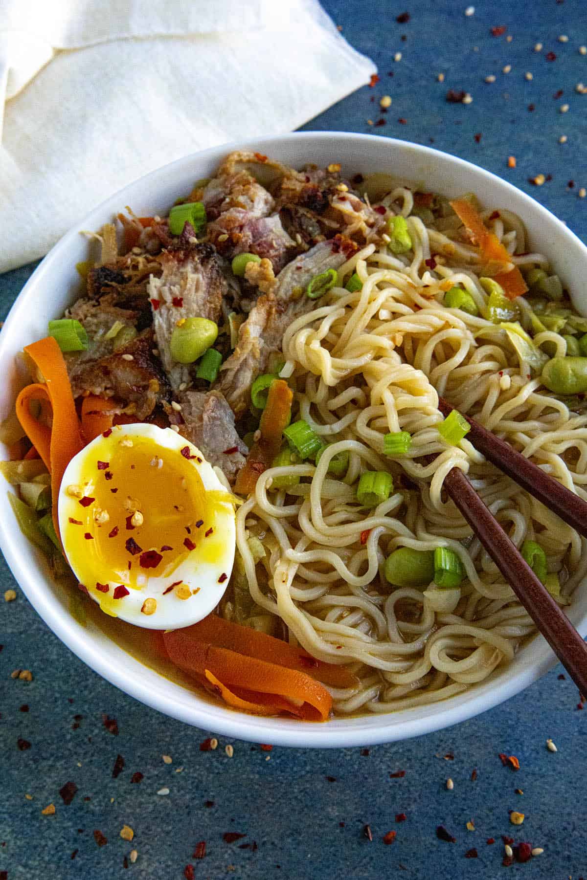 Mike taking a bite from a bowl of Miso Ramen