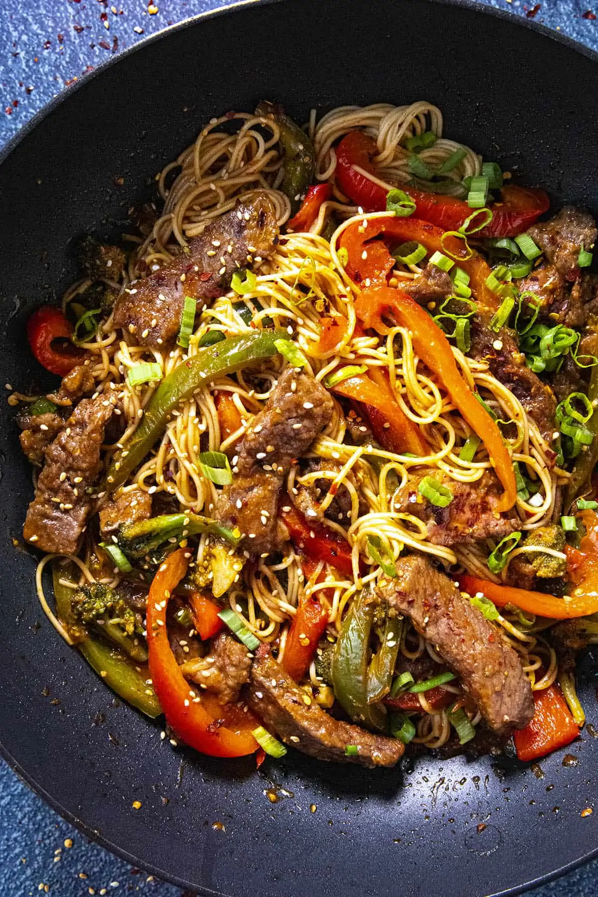 Spicy Beef Stir Fry with noodles in a pan with lots of vegetables.