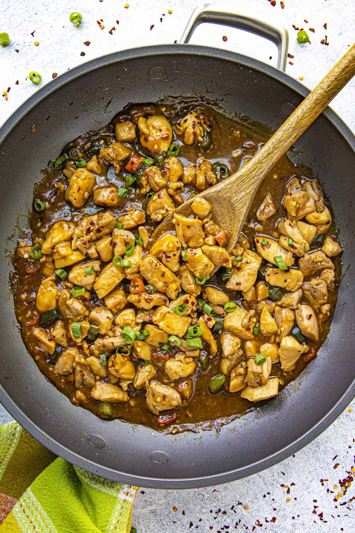 Mike taking a scoop of bourbon chicken from the pan