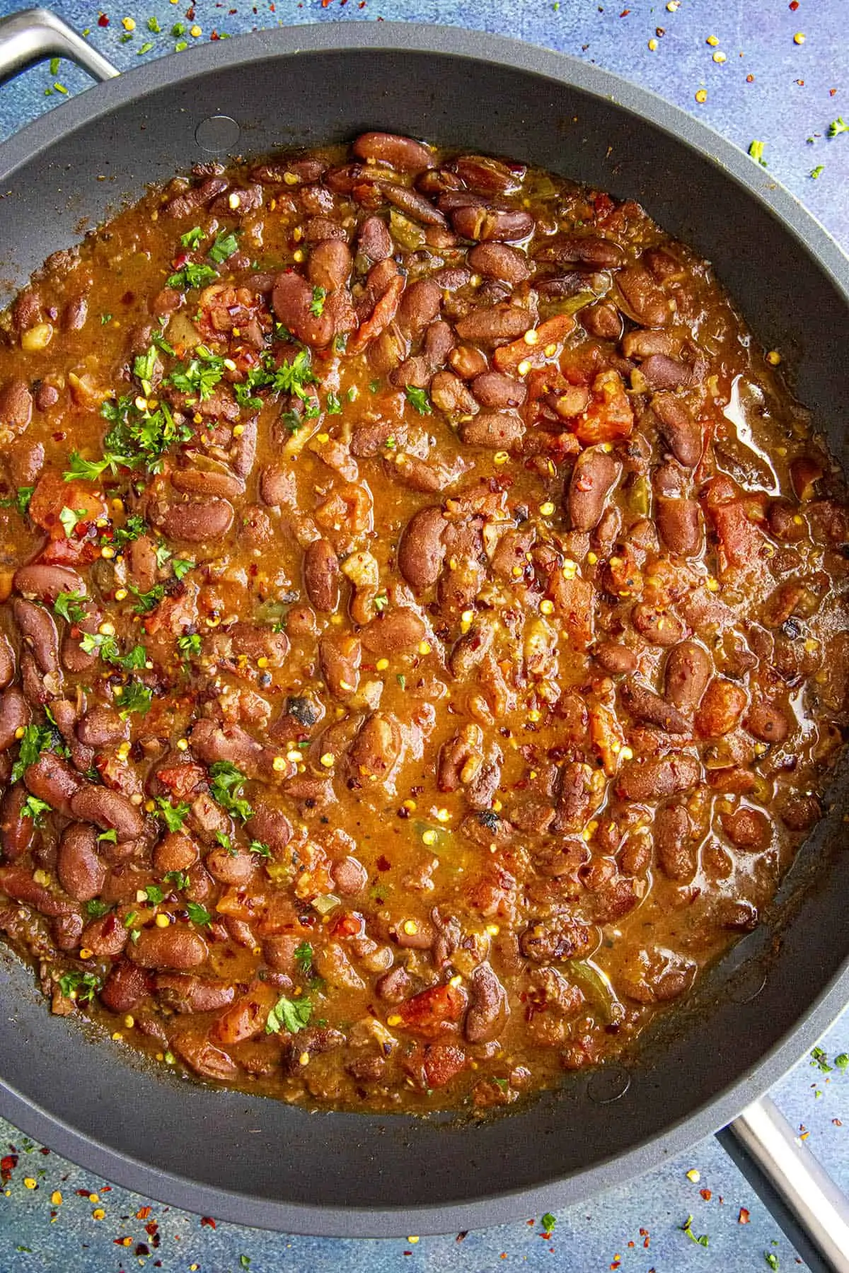 Charro Beans in a pan with garnish