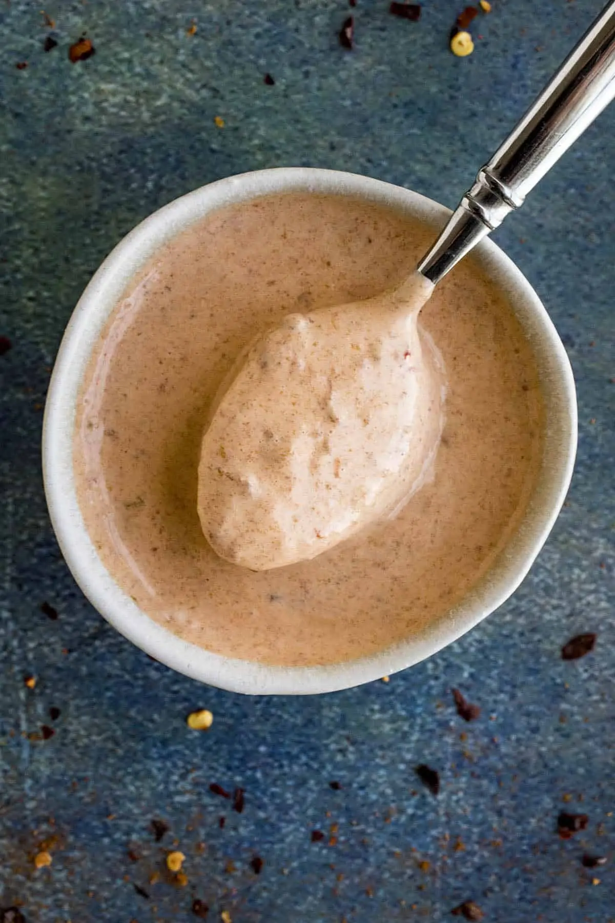 Creamy Chipotle Mayo on a spoon over a bowl.