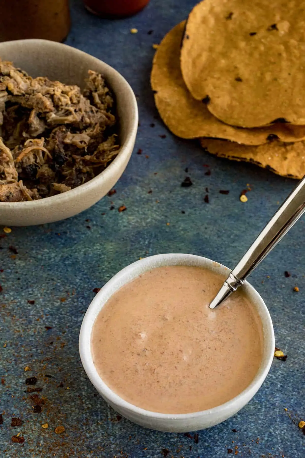 Chipotle Mayo in a bowl, served with pulled pork and tortillas.