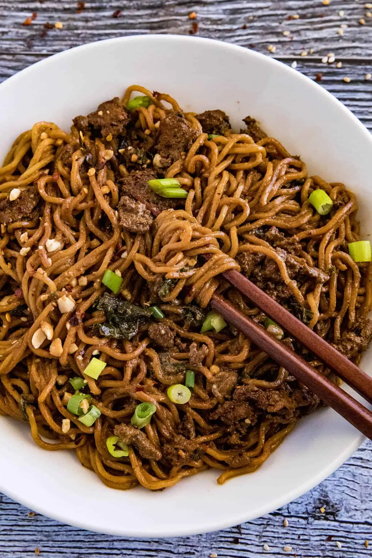 Dan Dan Noodles in a bowl with chopsticks