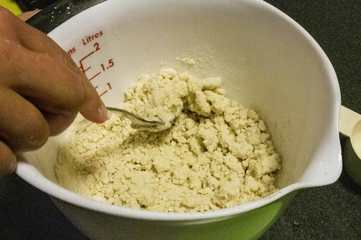 Mixing masa harina, water and salt to make homemade corn torillas