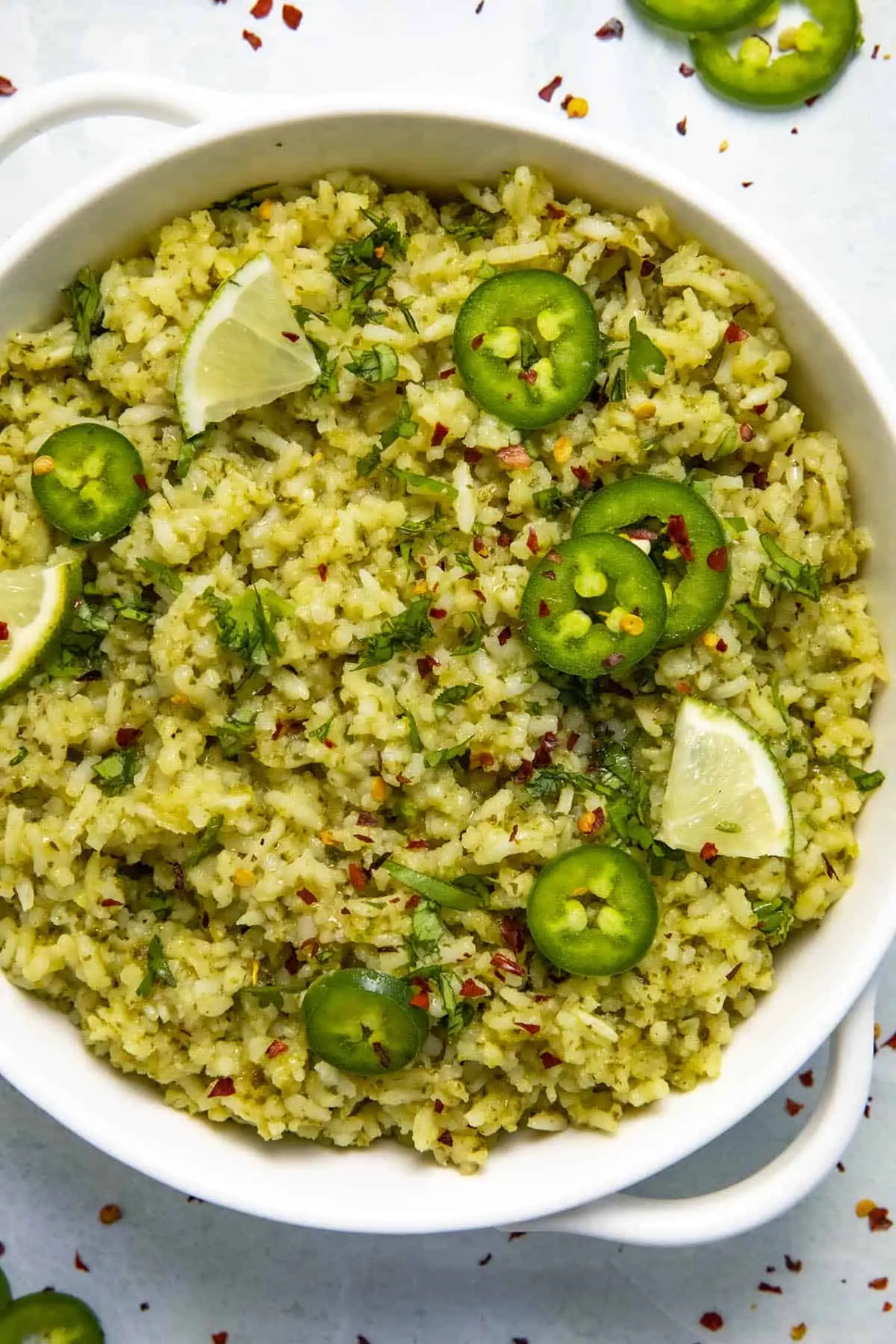 Arroz Verde in a bowl with garnish.