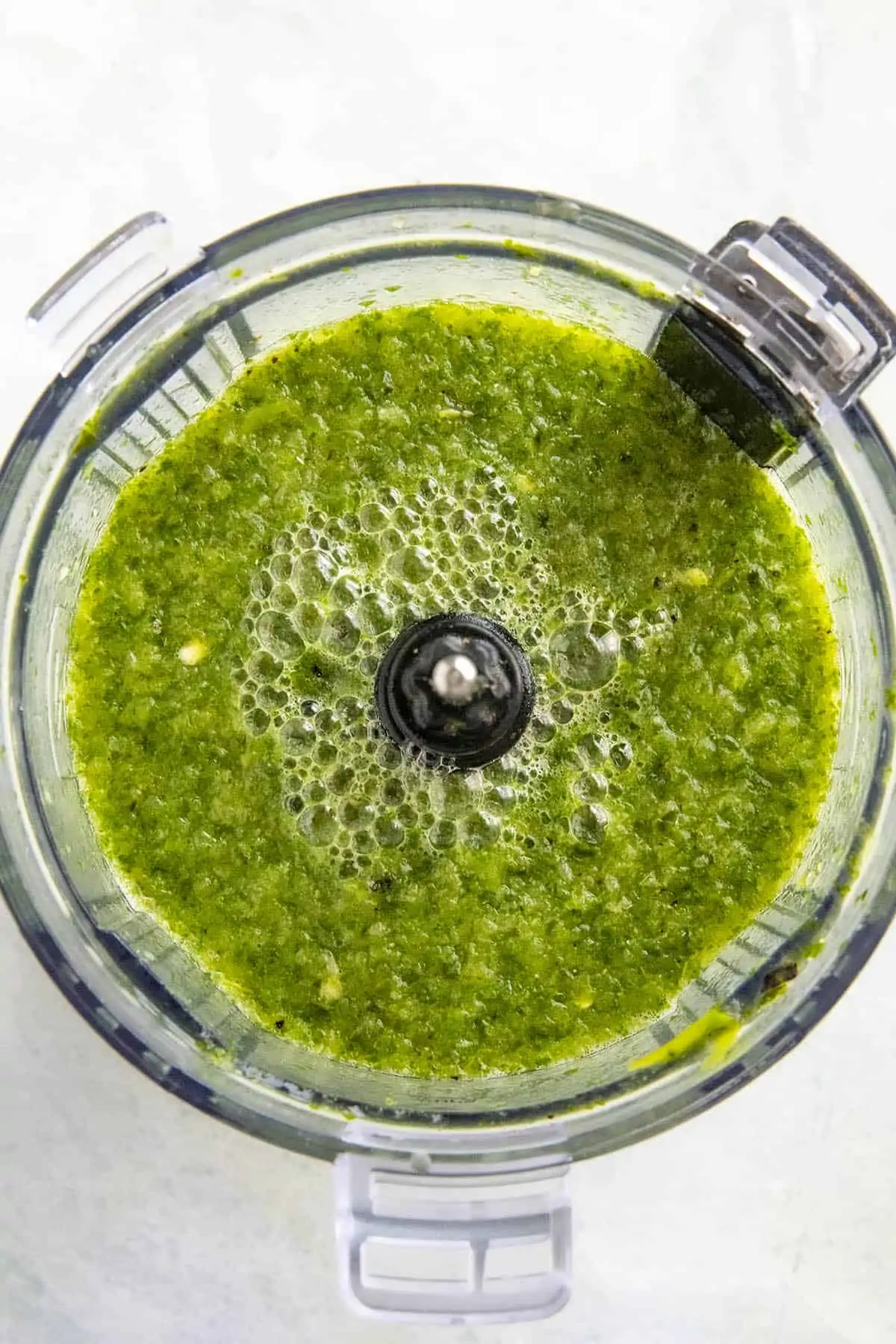 Pureed peppers and herbs in a food processor