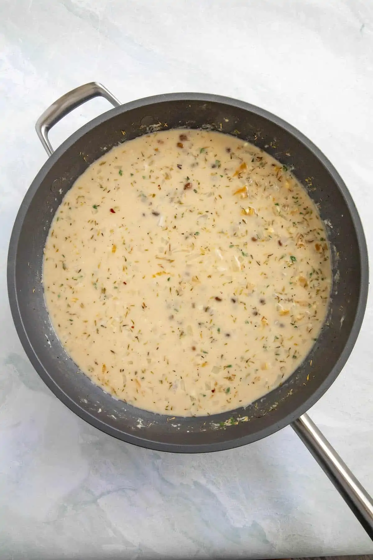 Jamaican Rice and Peas simmering in a pan.