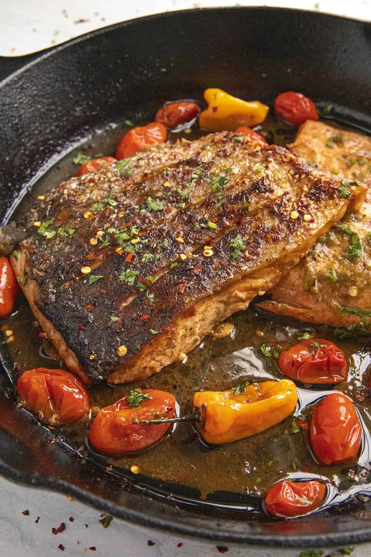 Jerk salmon served in a big skillet.