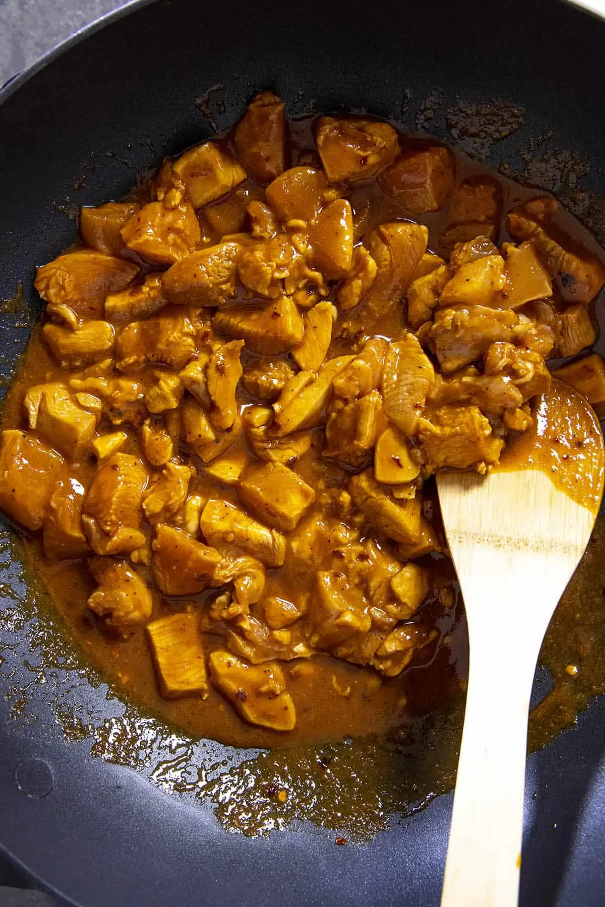 Cooking chicken in a hot pan to make Korean chicken.