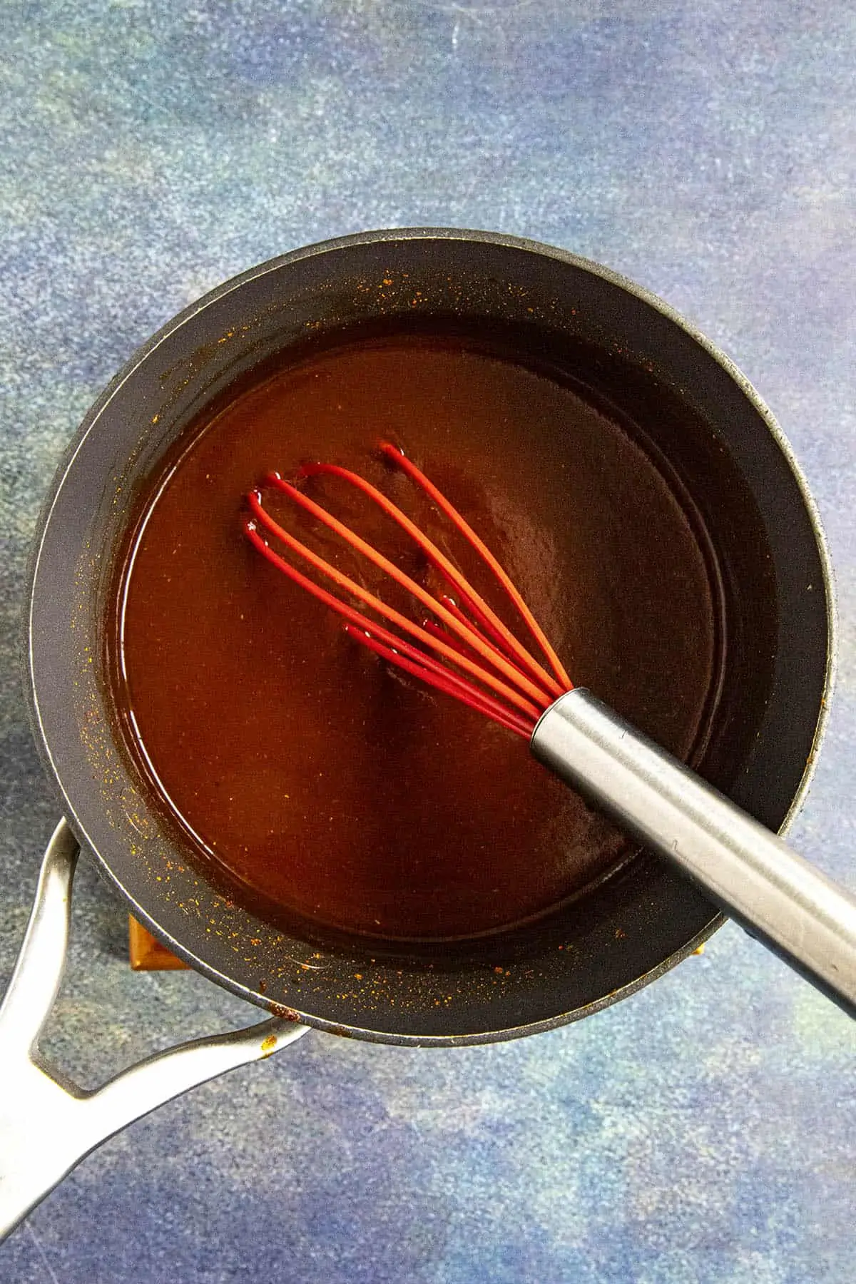 Whisking Homemade Mumbo Sauce Ingredients in a pot