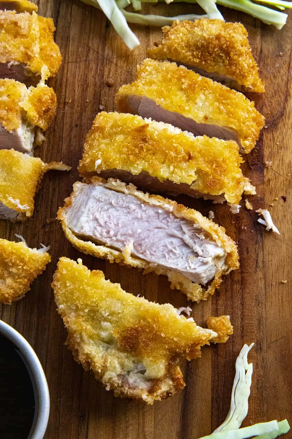 Freshly sliced Pork Katsu on a cutting board.