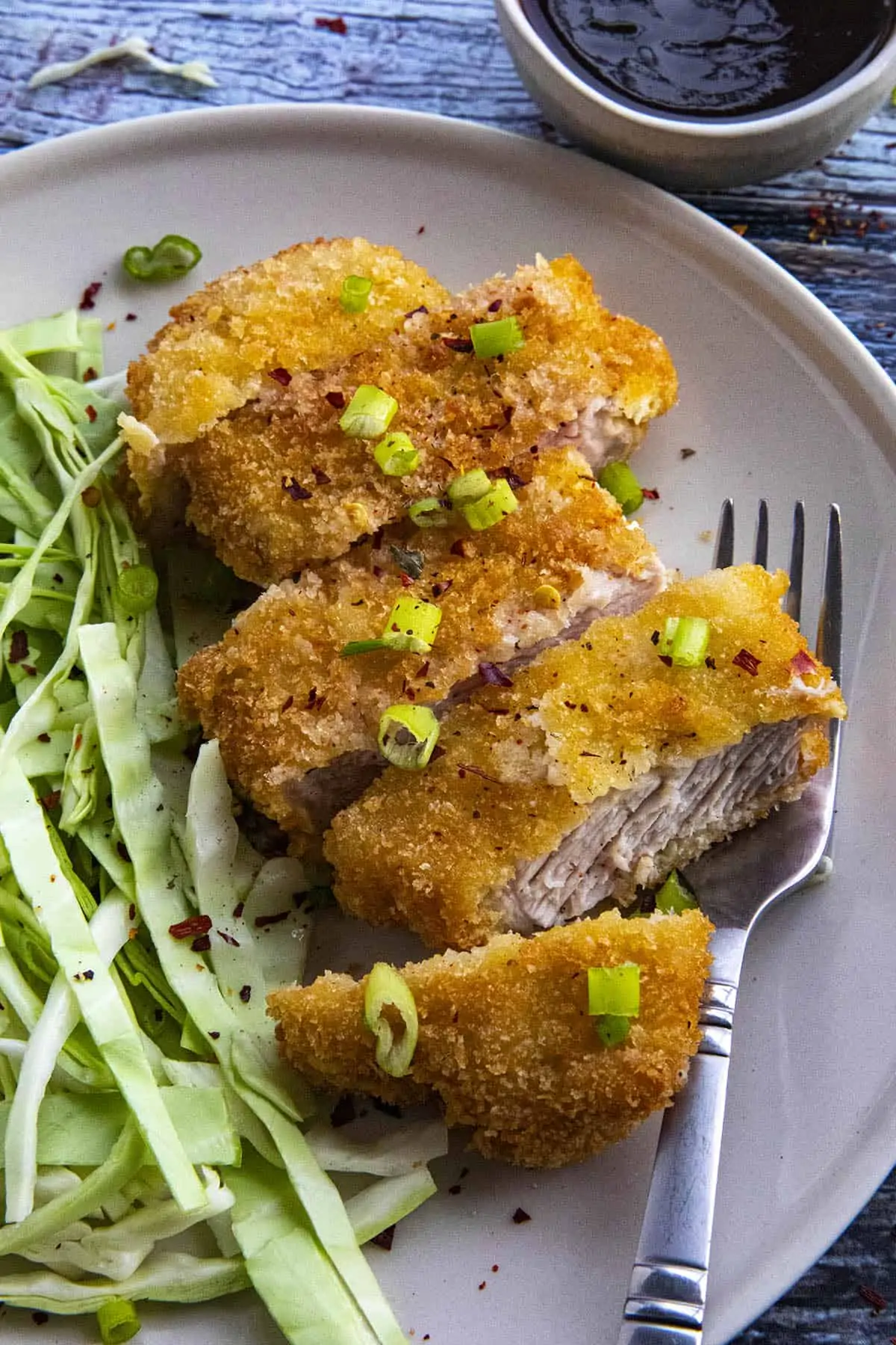 Pork Katsu on a plate, waiting for tonkatsu sauce.