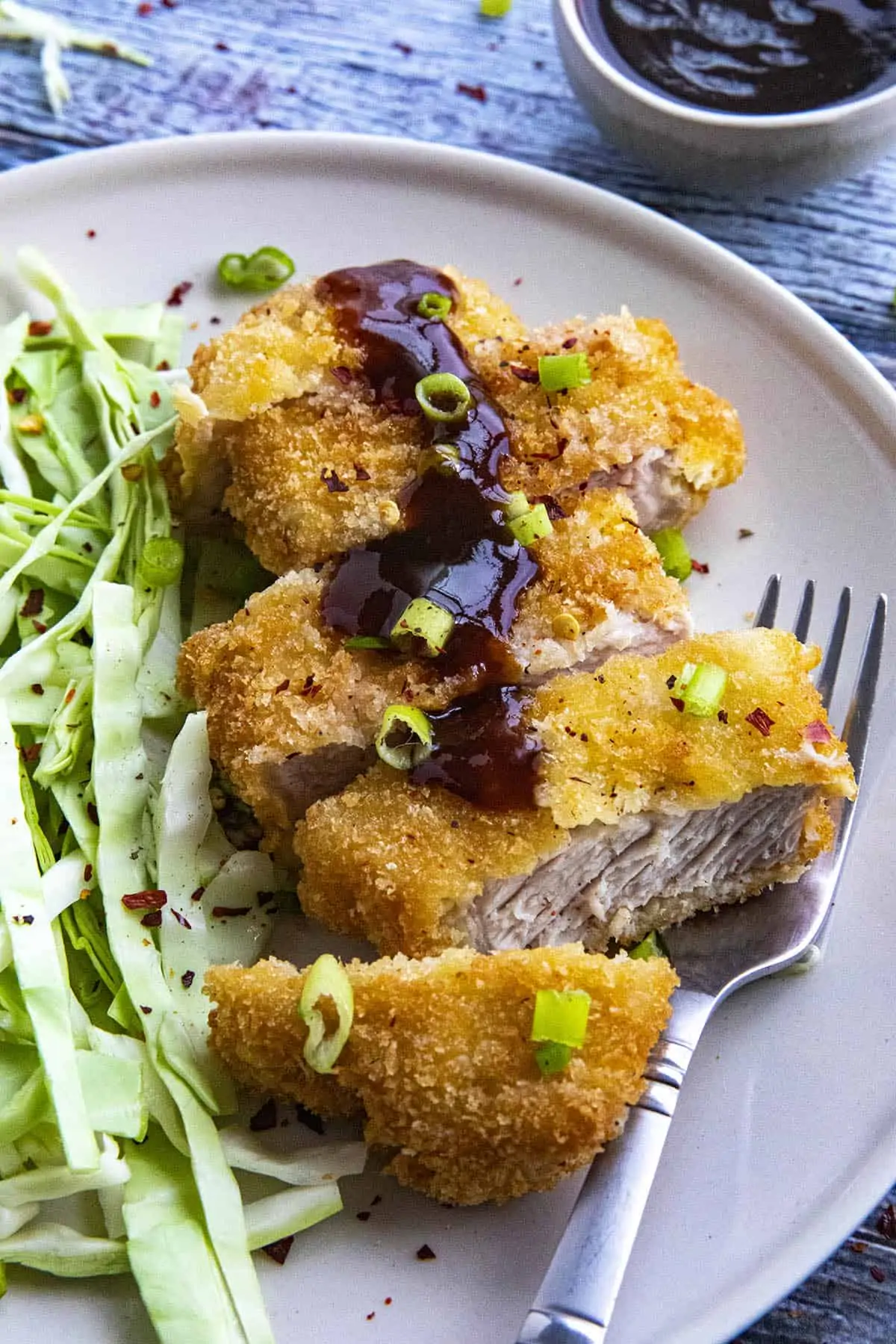 Pork Katsu with tonkatsu sauce on a plate, ready to serve.