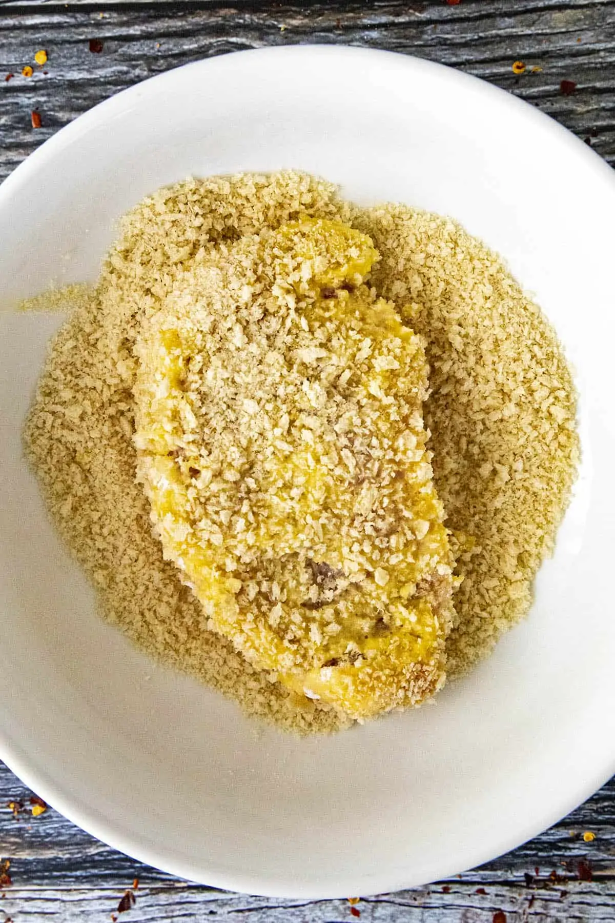 Breading the pork cutlet with panko bread crumbs.