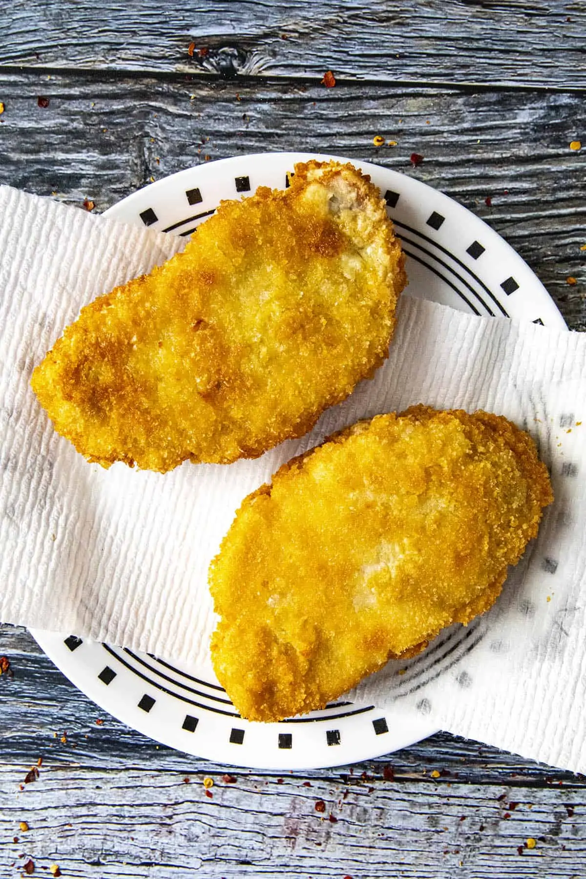 Fried panko breaded pork cutlets on a plate.