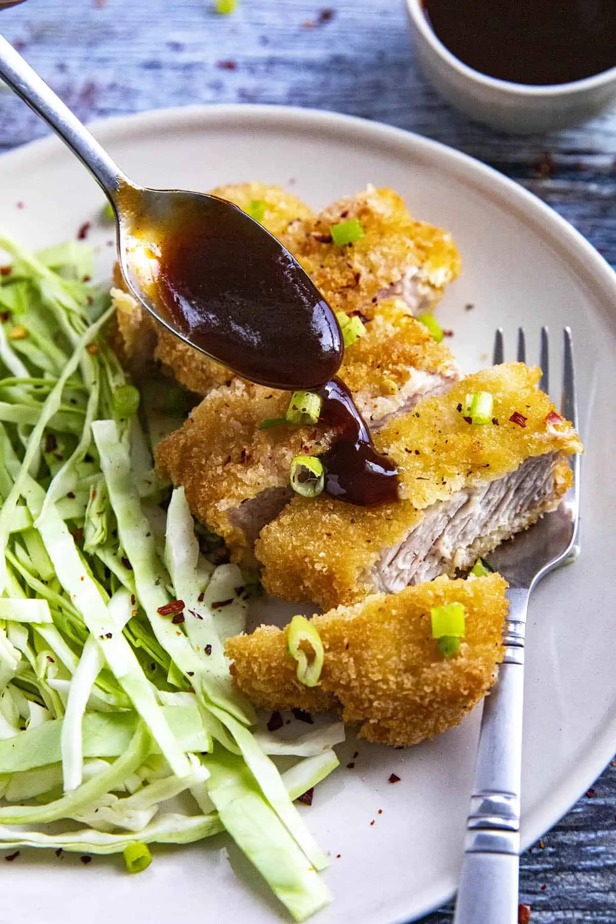 Drizzling homemade Tonkatsu Sauce over Tonkatsu (Japanese fried pork cutlet)