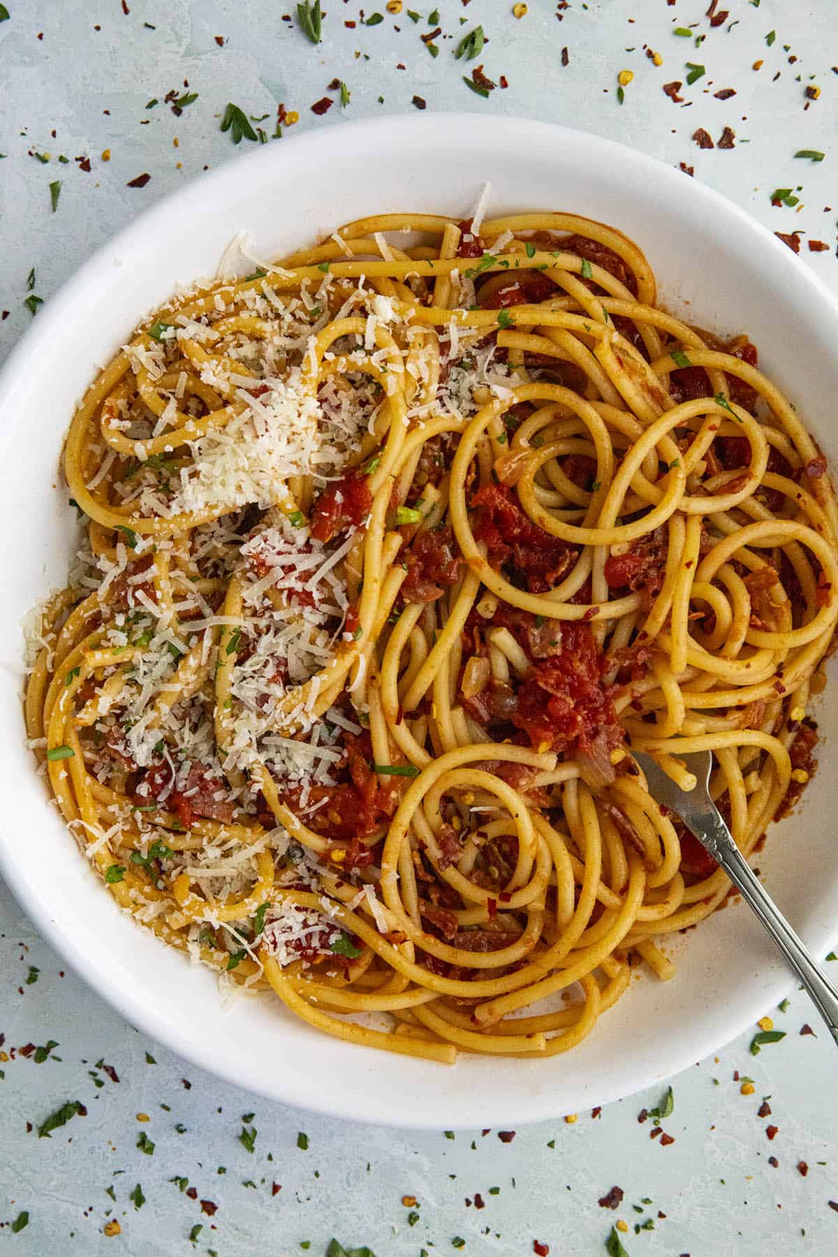 Bucatini all Amatriciana in a bowl with parmesan cheese