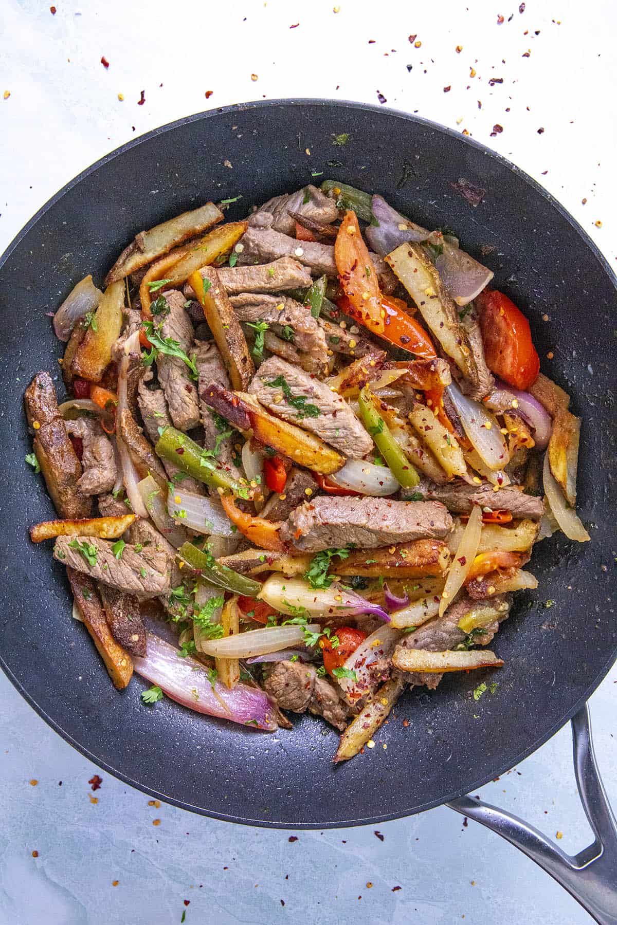 Peruvian Beef Stir Fry with French Fries (Lomo Saltado) in a pan, ready to serve