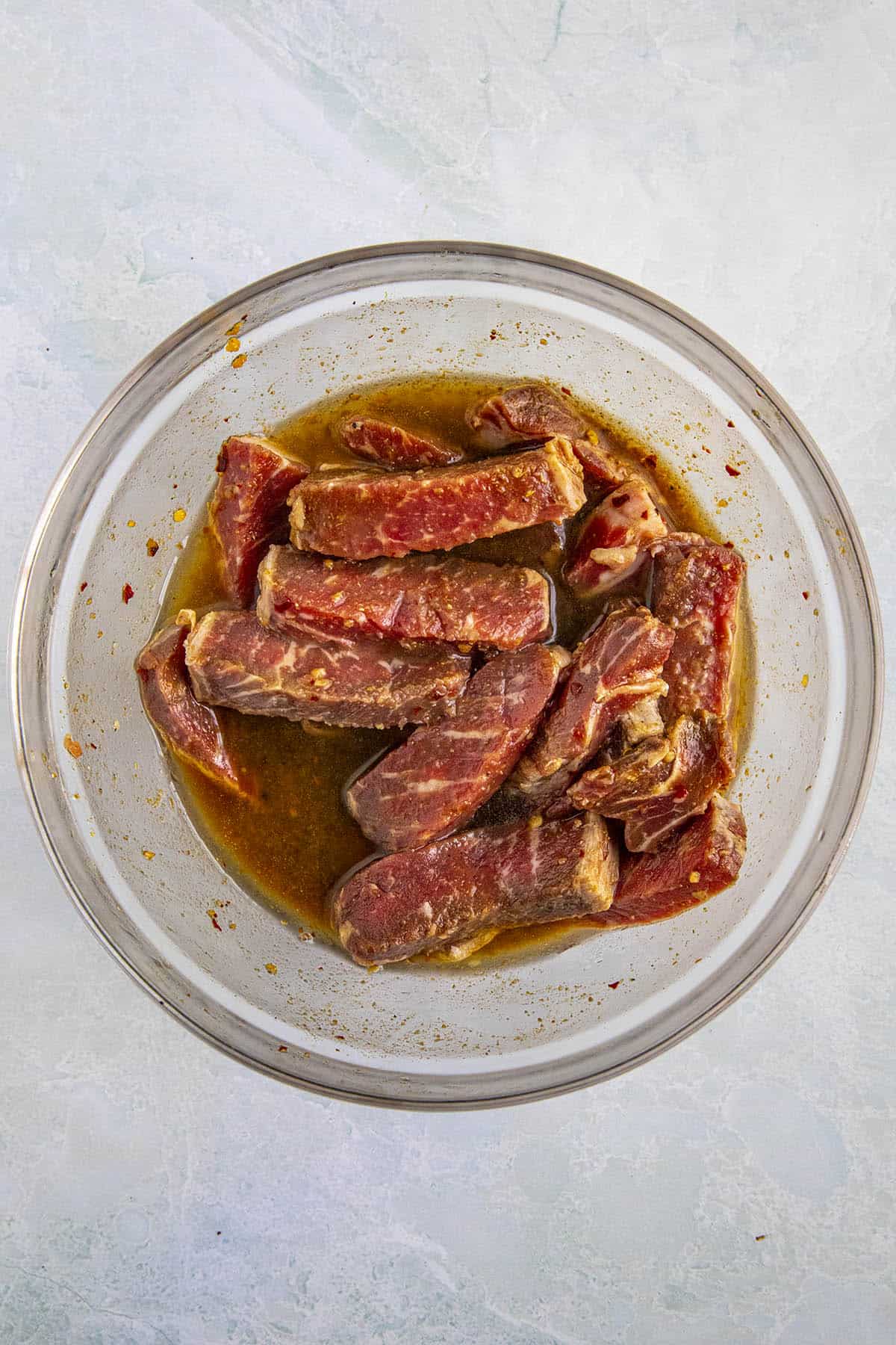 Marinating the beef to make lomo saltado (Peruvian beef stir fry with french fries)