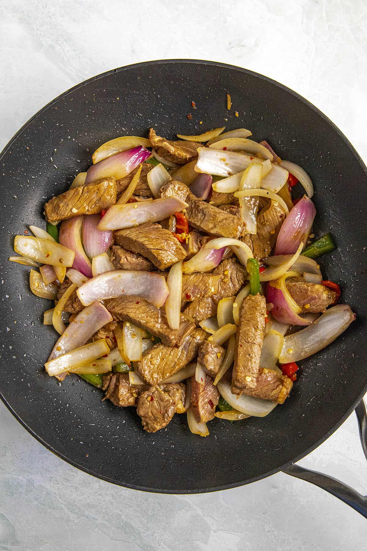Cooking the beef strips with the vegetables