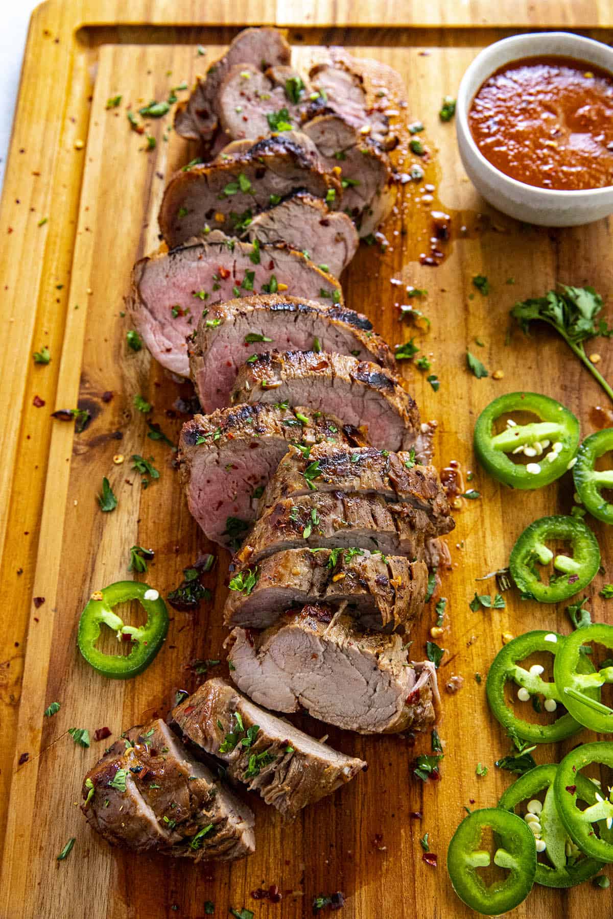 Sliced and grilled marinated pork tenderloin with bbq sauce, ready to serve