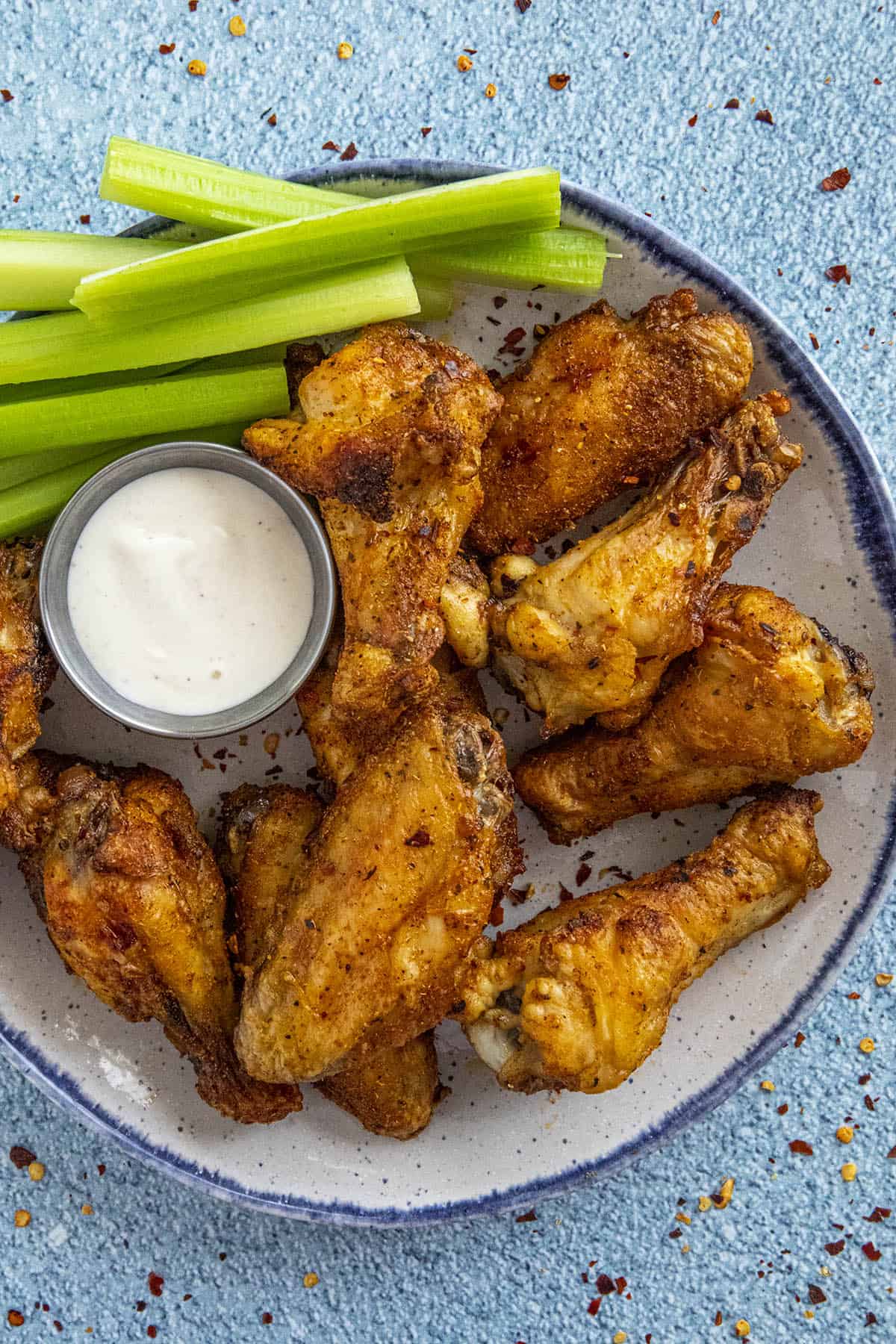 Crispy Air Fryer Chicken Wings on a plate with celery and ranch dressing