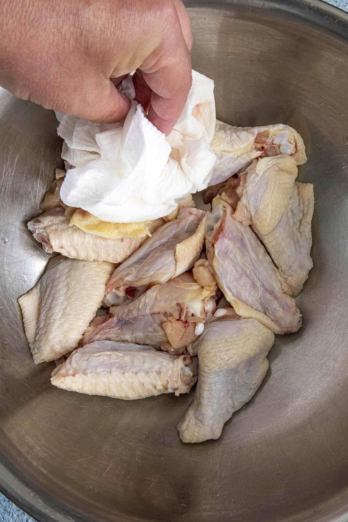 Patting dry the chicken wings