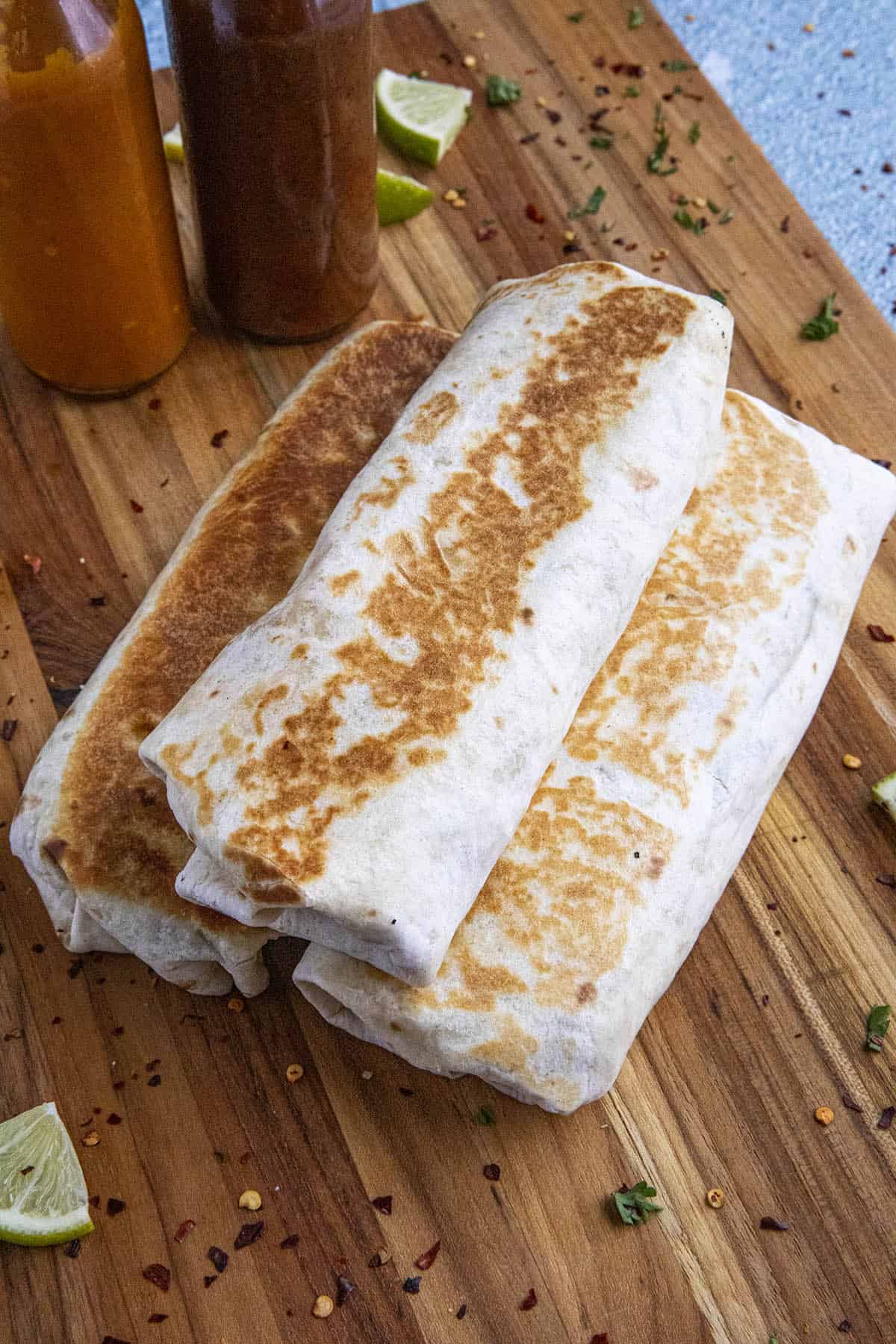 3 bean burritos on a platter.