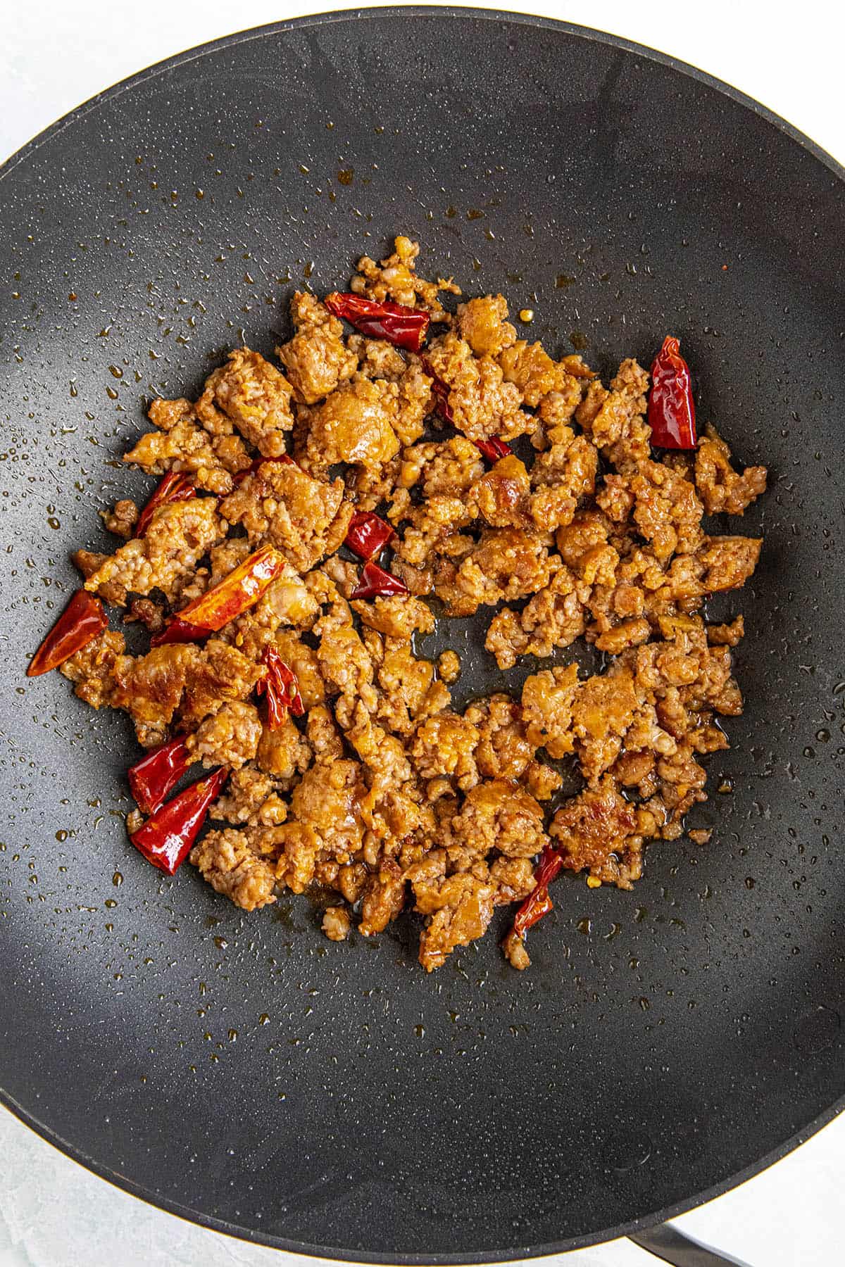 Cooking the pork and peppers in a hot pan