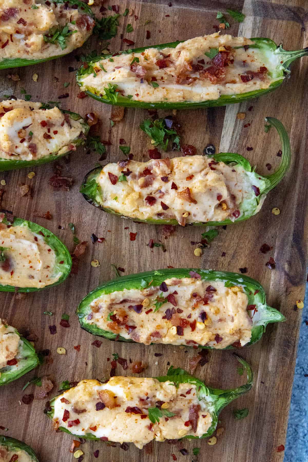 Grilled Jalapeno Poppers topped with crumbled bacon