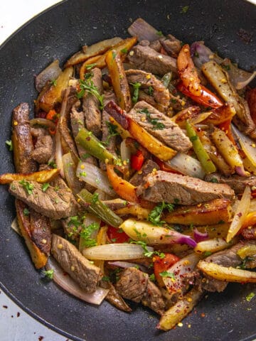 Peruvian Beef Stir Fry with French Fries (Lomo Saltado) in a pan