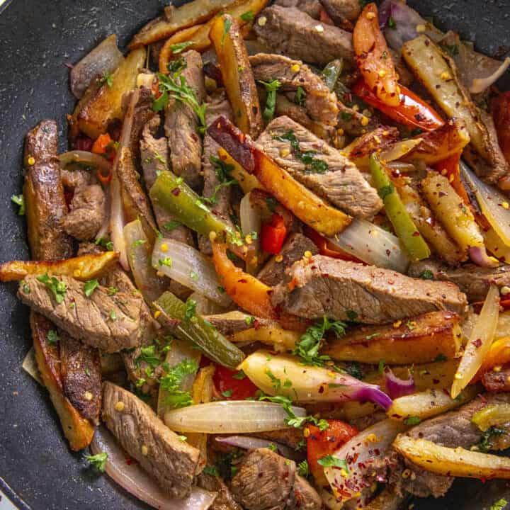 Peruvian Beef Stir Fry with French Fries (Lomo Saltado) in a pan