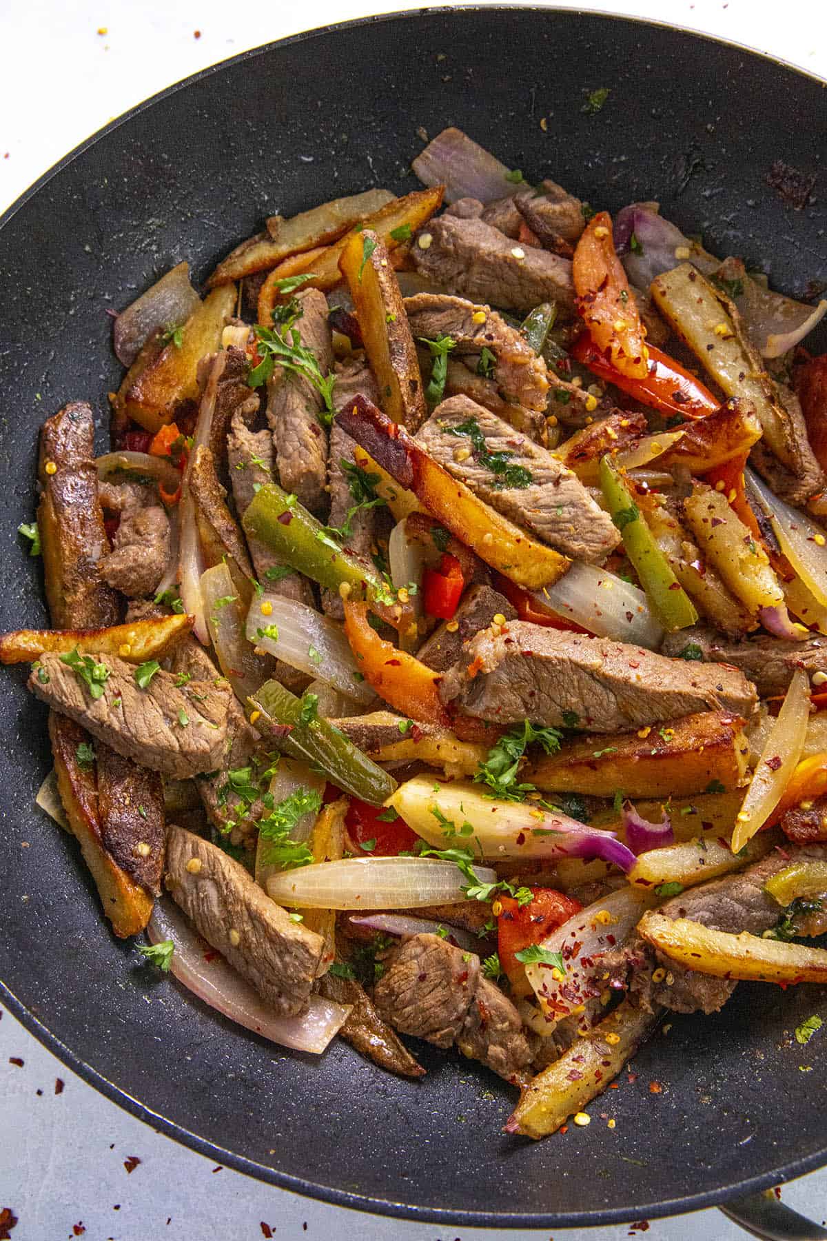 Peruvian Beef Stir Fry with French Fries (Lomo Saltado) in a pan