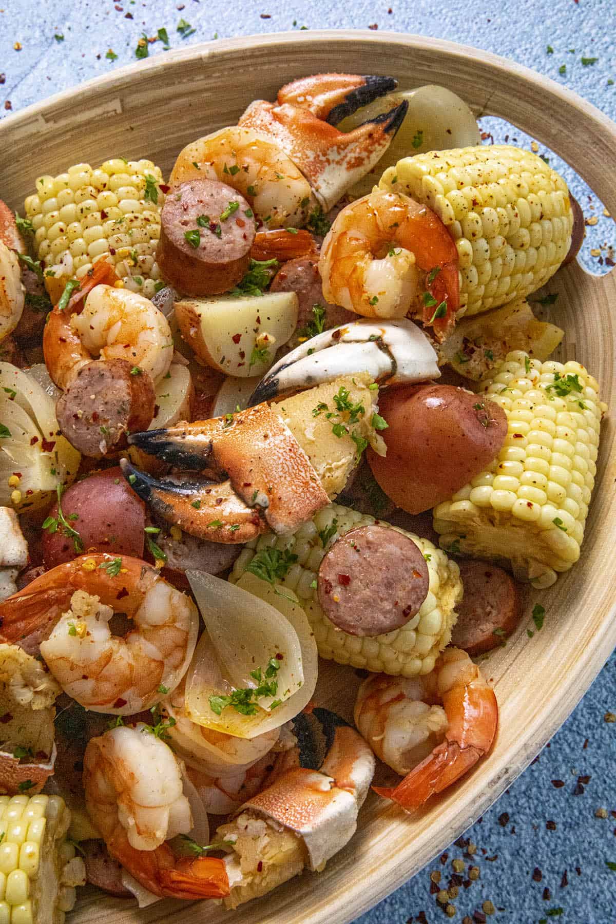 Chunky pieces of seafood, sausage and corn on a platter, low country boil style