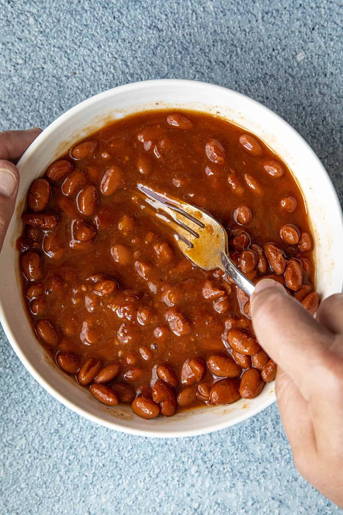 Mashing pinto beans to make a bean burrito