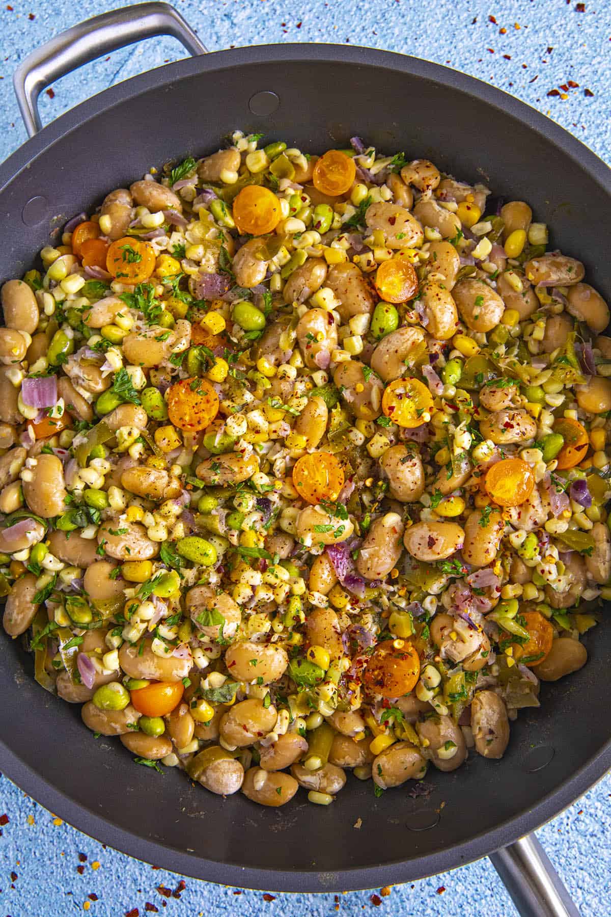 Succotash in a pan with lots of garnish