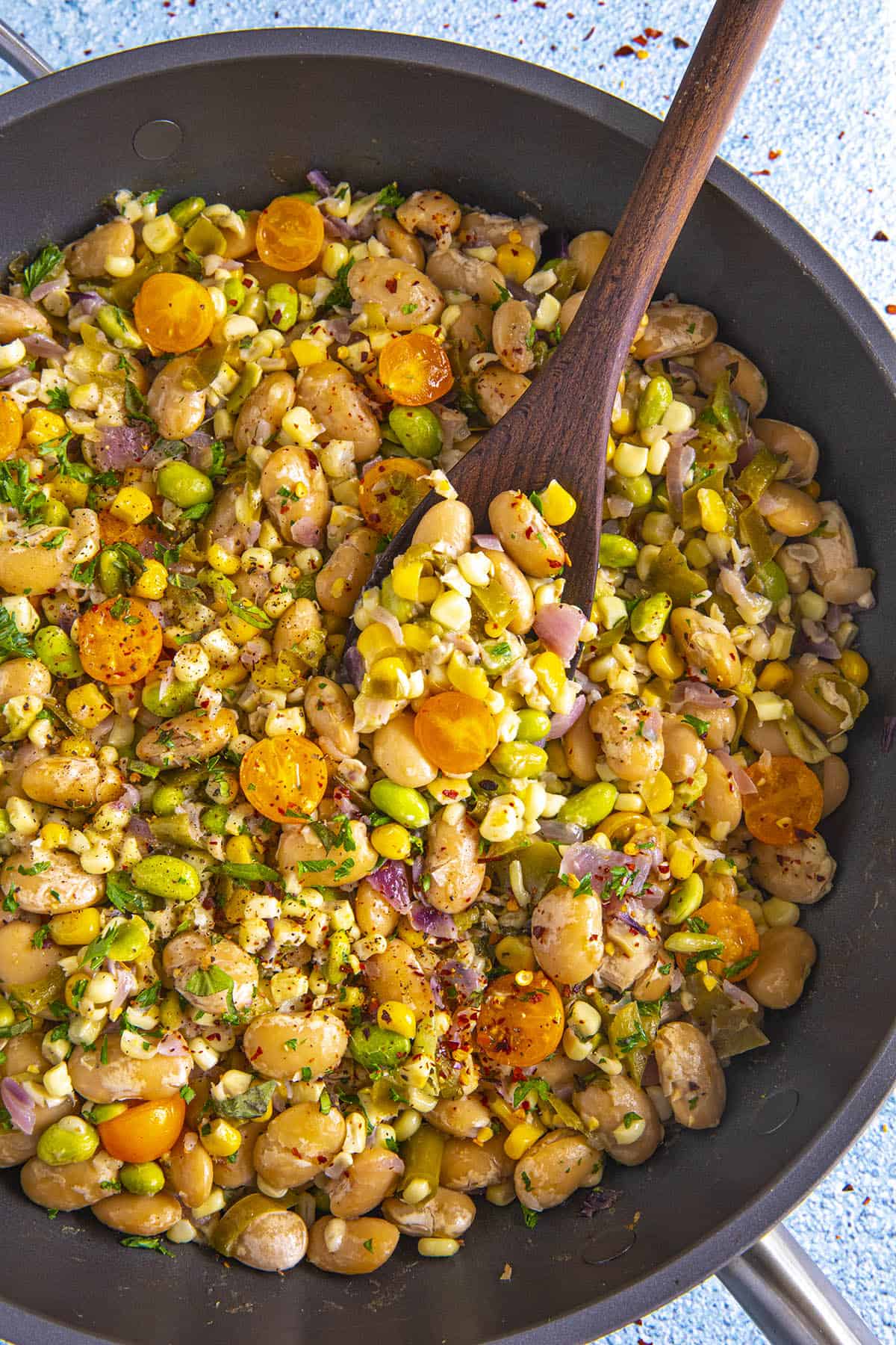 Mike serving a scoop of succotash from the hot pan