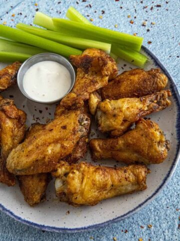 Crispy Air Fryer Chicken Wings with celery and ranch dressing