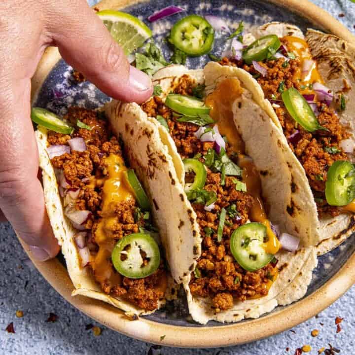 Trying one of the Chorizo Tacos serve hot and ready.