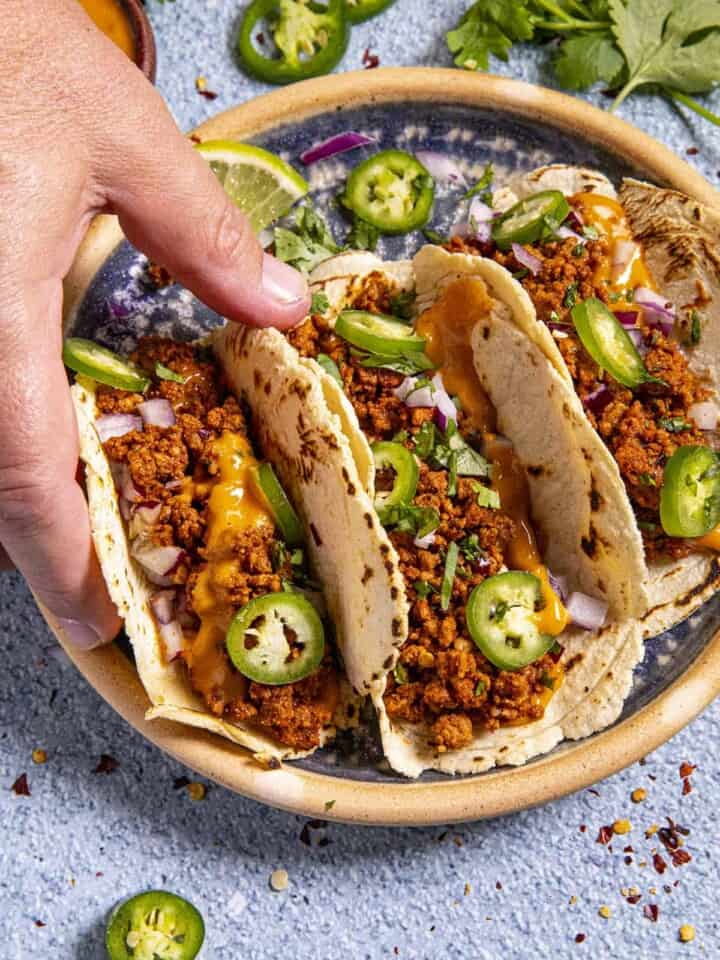 Trying one of the Chorizo Tacos serve hot and ready.