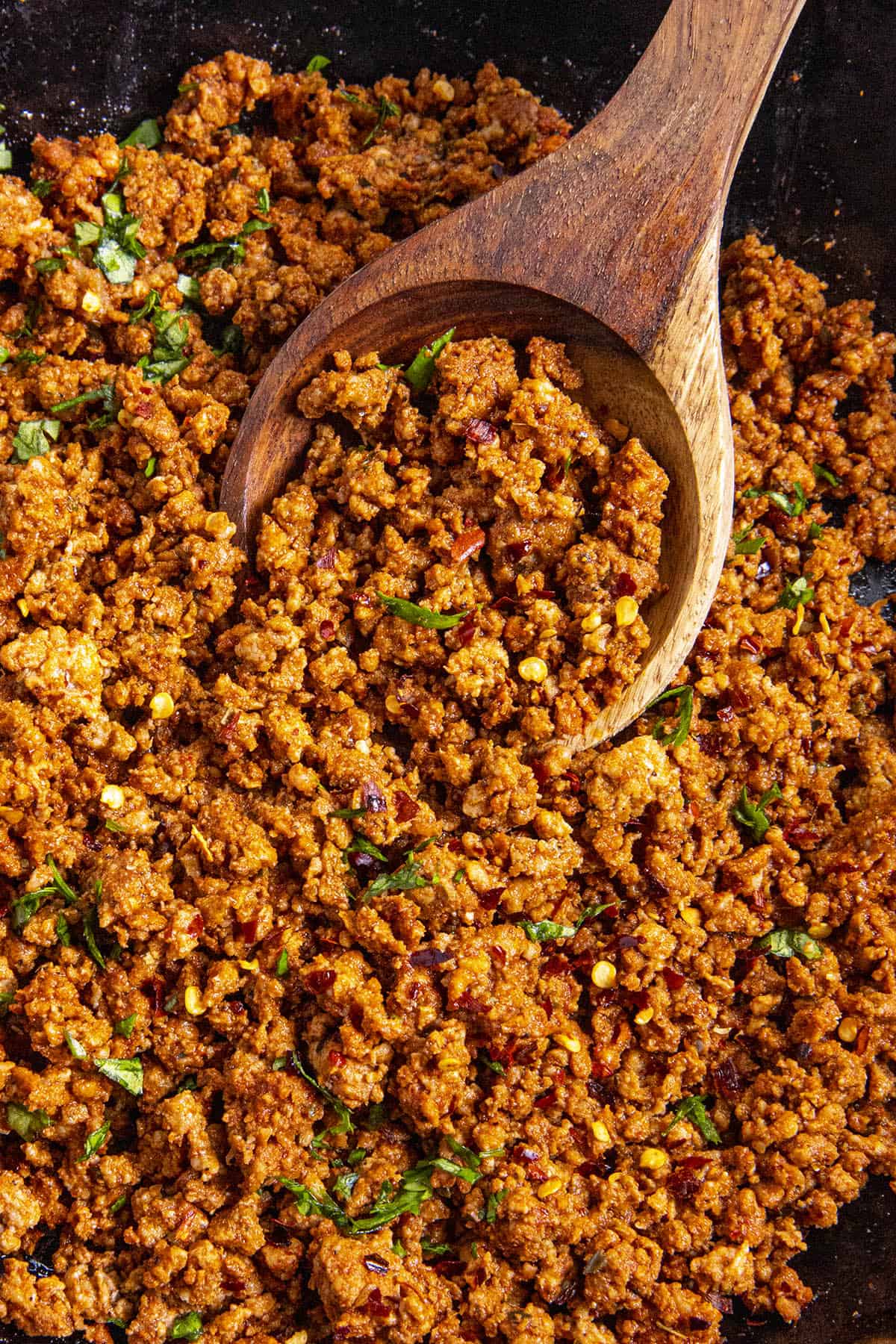 Scooping up Homemade Chorizo from the pan