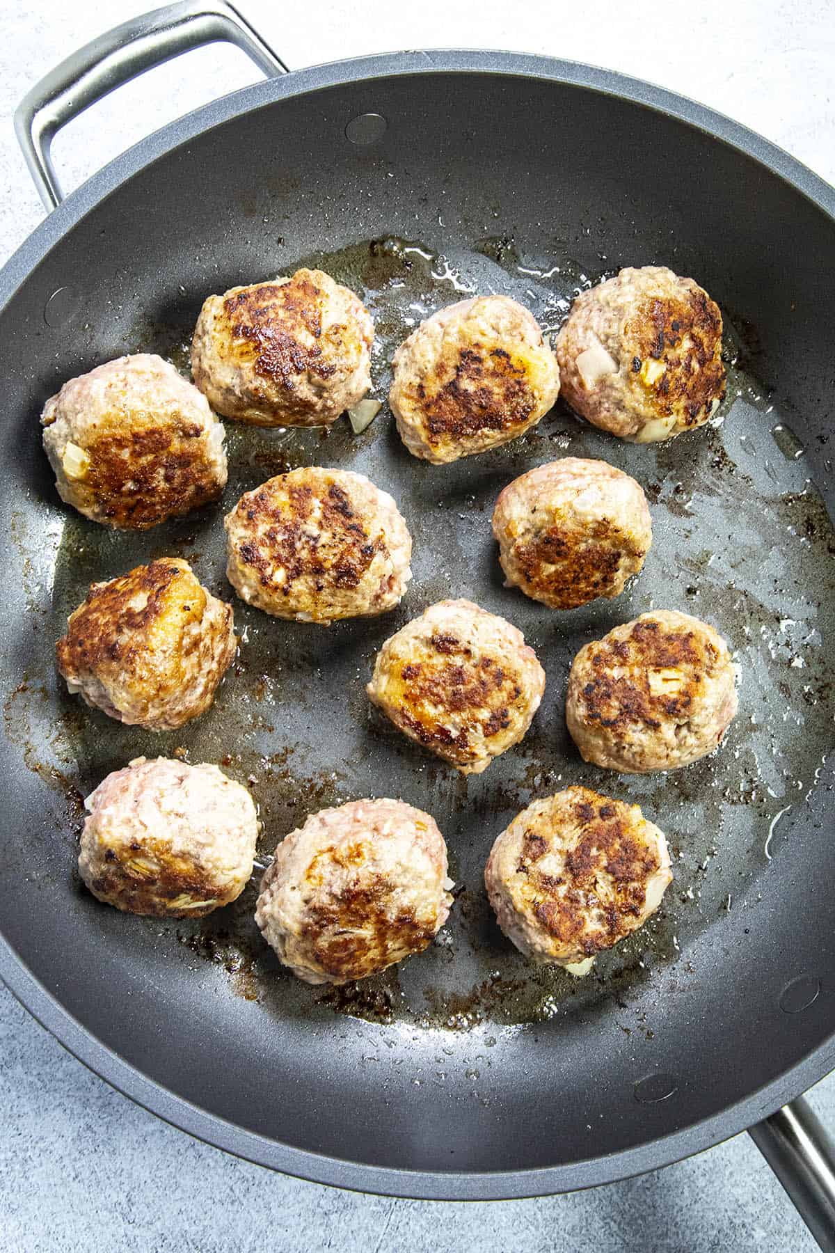 Sauteeing meatballs to make Albondigas