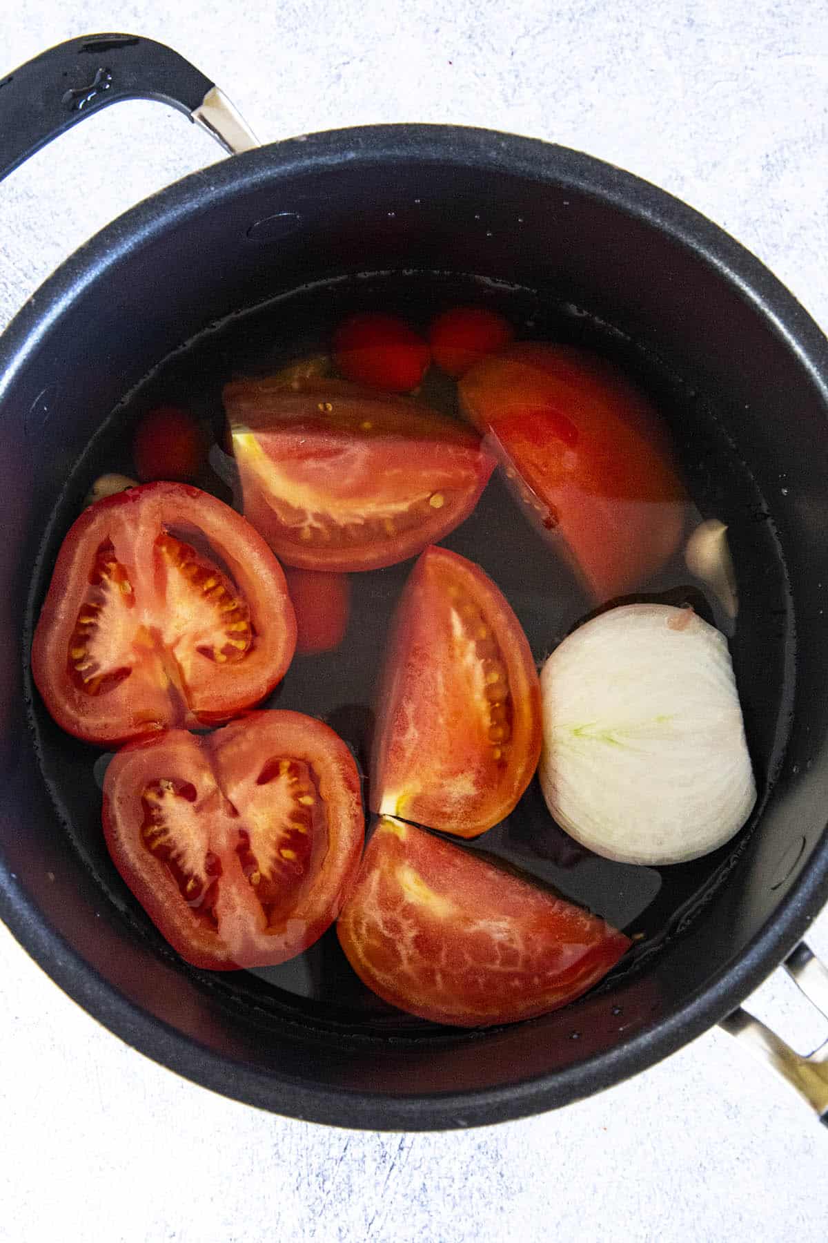 Simmering tomatoes and onions to make Soup base for Albondigas Soup