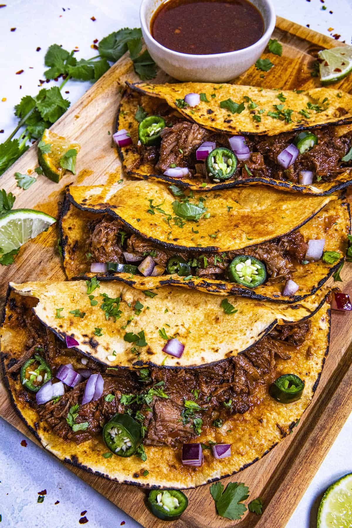 Birria Tacos on a platter with garnish
