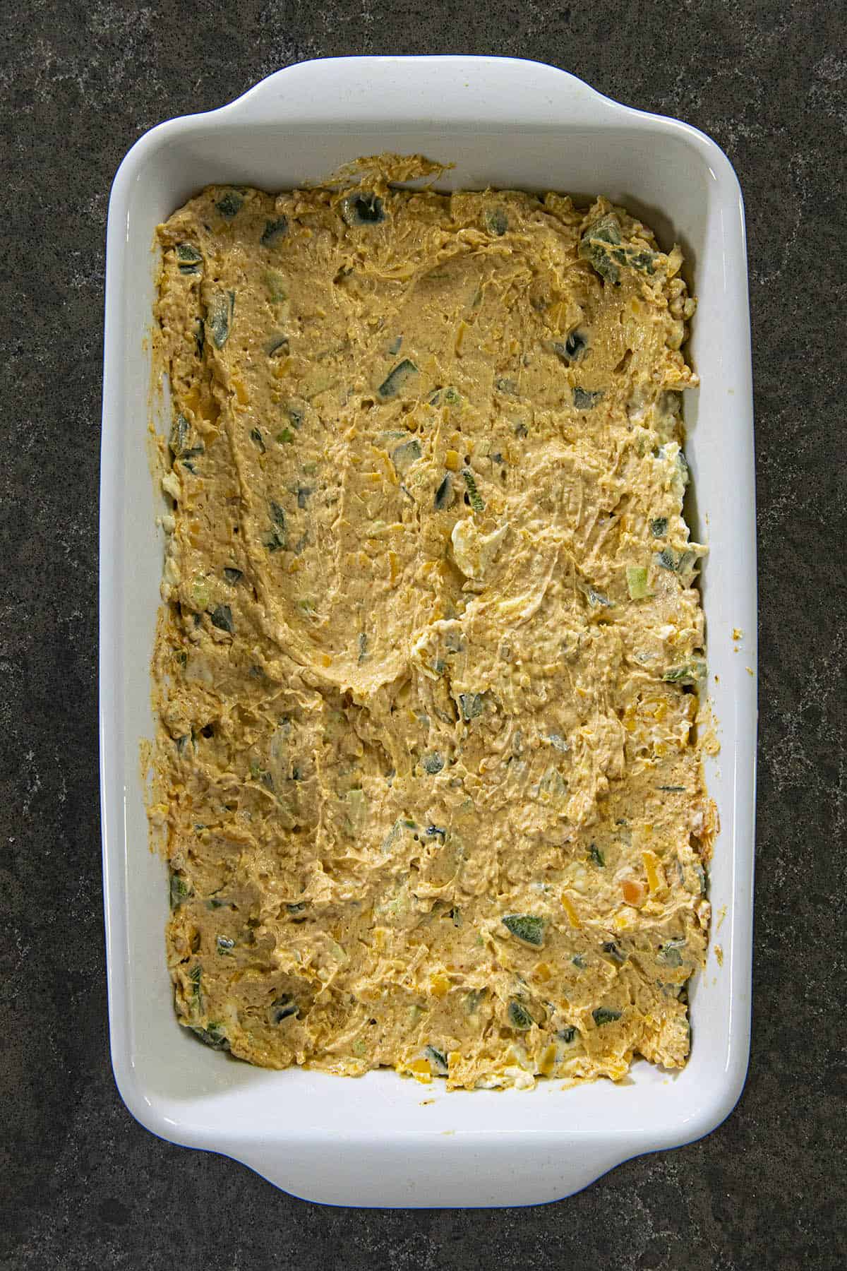 Jalapeno Popper Dip spread into a baking dish