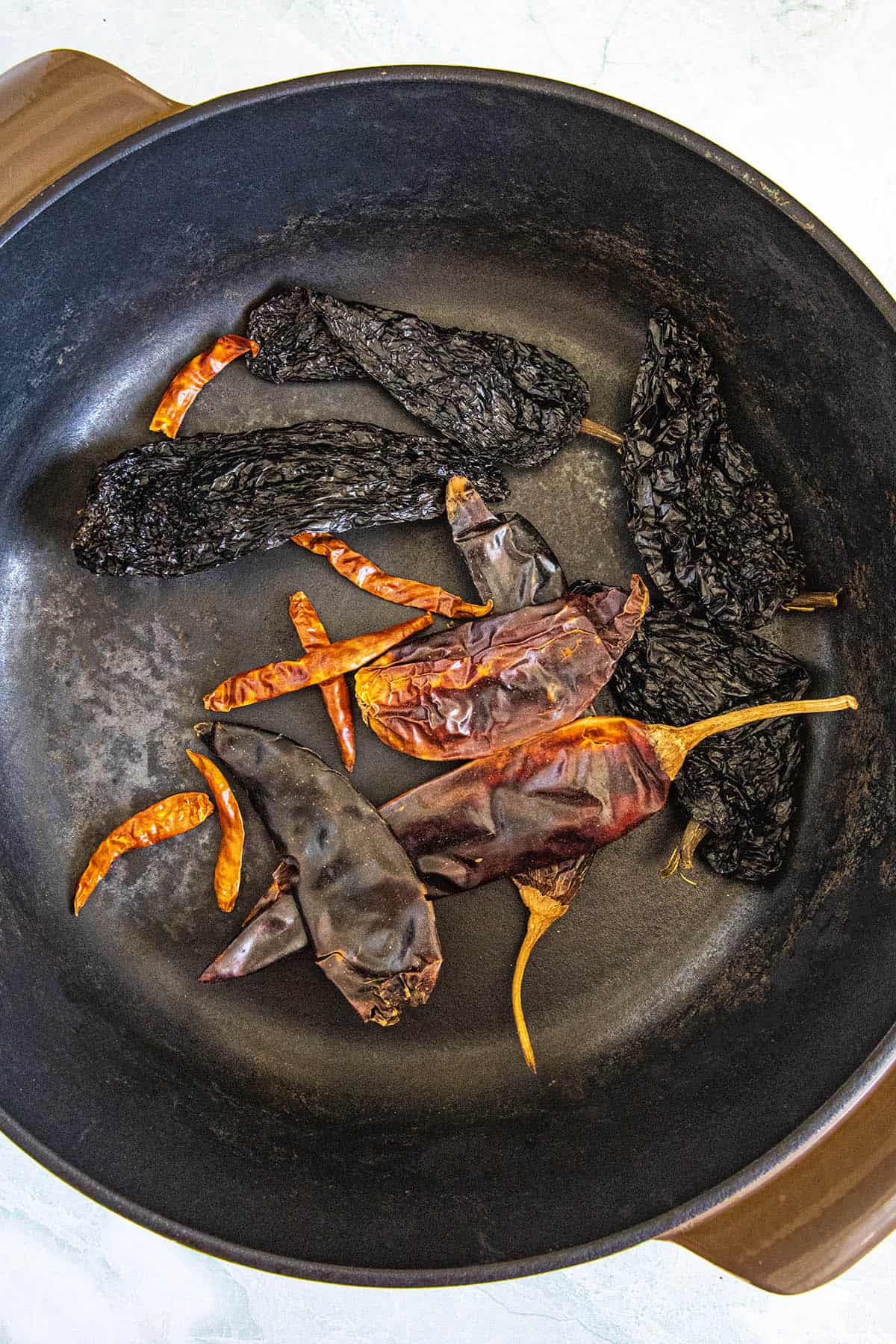 Toasting the chilies to make birria