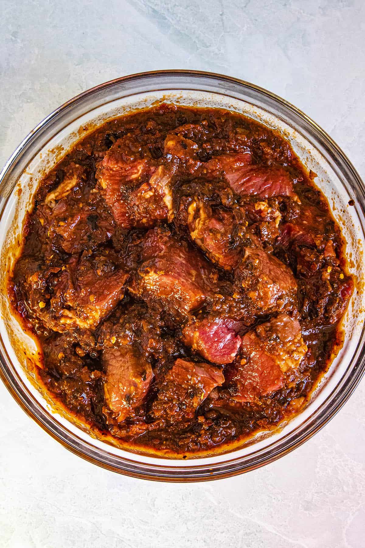 Coating the cubed meat in chili paste